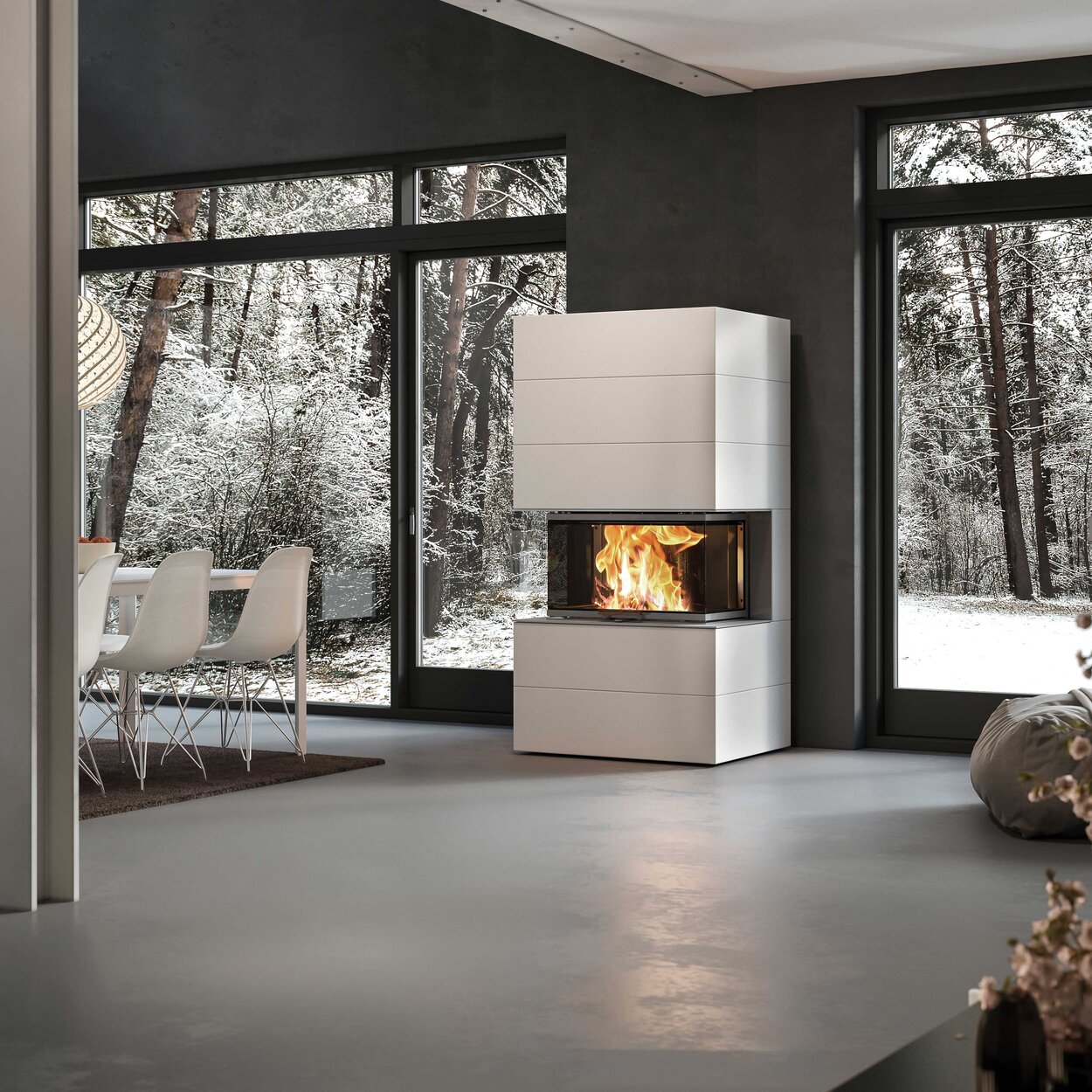 Wood fireplace VISIO 3 ELEMENT installed in white-painted concrete elements as a free-standing 3-sided fireplace in the centre of the room