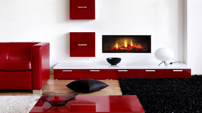 Feu électrique Opti-V-Single installé dans un salon avec des meubles rouges sur un mur blanc