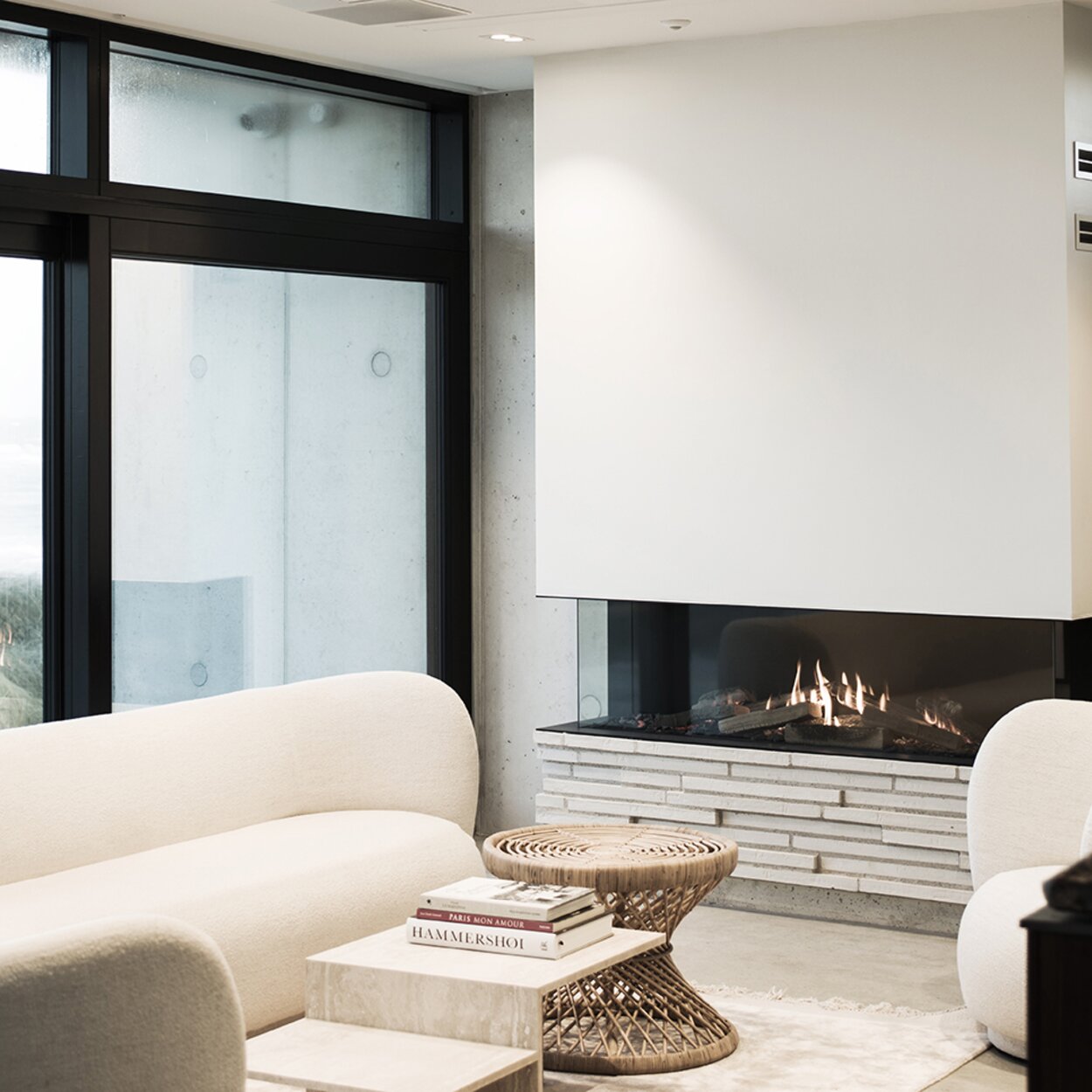 VISIO 160 gas fireplace insert with glass on three sides, white wall and modern living area