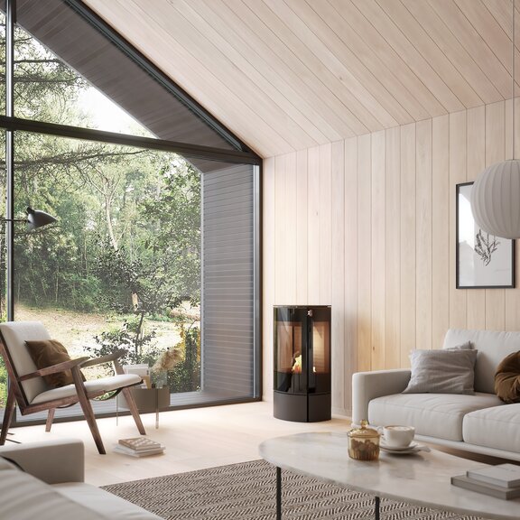 Poêle à bioéthanol CARO 90 BIO noir dans un salon lumineux avec beaucoup de bois