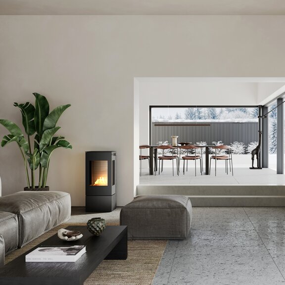 Poêle au bioéthanol NEXO 100 BIO de couleur noire dans le salon avec un canapé