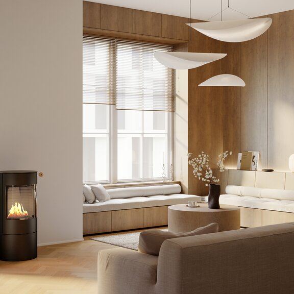 Poêle à bioéthanol VIVA 100 L noir dans un salon moderne et lumineux avec un coin salon confortable
