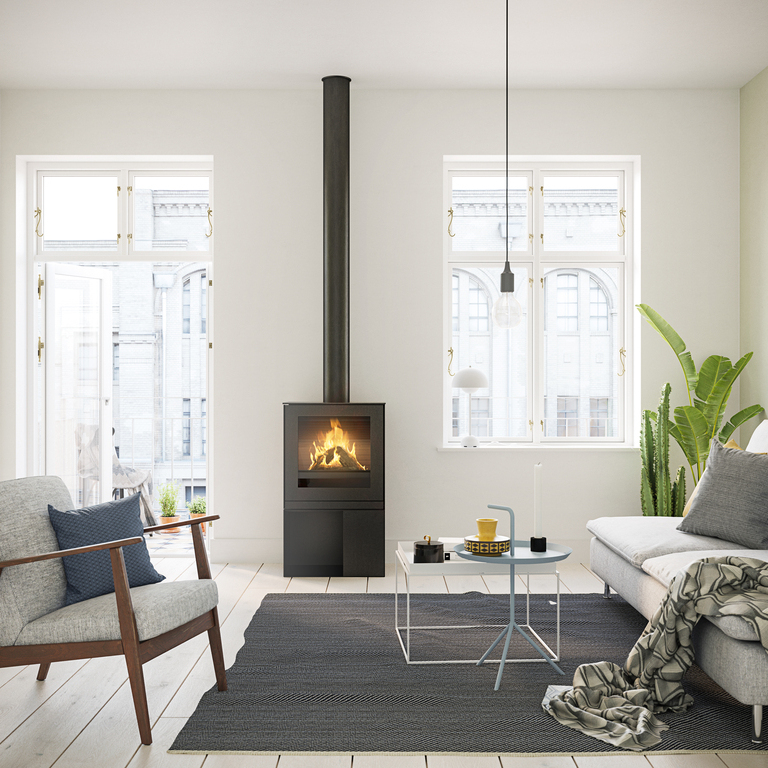Gas stove Q-TEE 2 with steel door and practical base unit in a stylish flat in the centre of the city