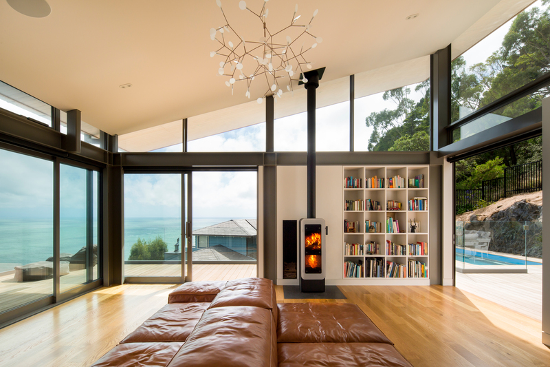 Wood stove bionic fire EVO in the colour black with white glass door in the living room by the sea