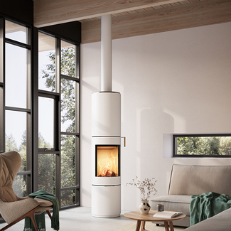 PILAR stove in white with steel door and oak handle in a modern living room with large windows