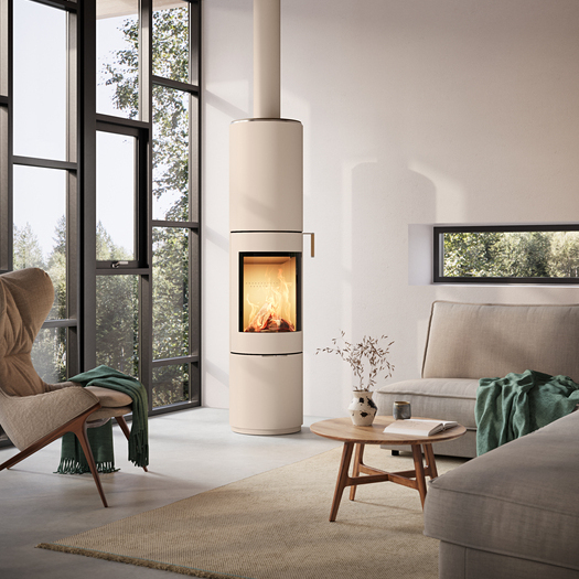 PILAR stove in sand with steel door and oak handle in a modern living room with large windows
