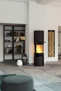Wood stove VIVA 160 L in black with glass door in a spacious, modern living room