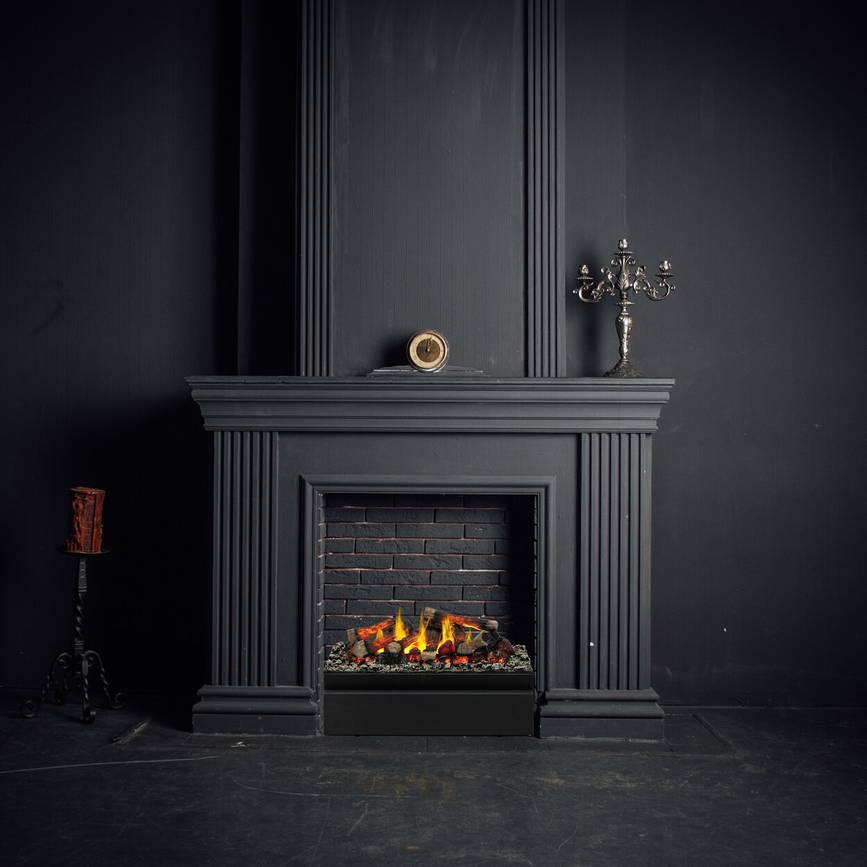 The Juneau electric fire was installed in a disused fireplace made of black stone.
