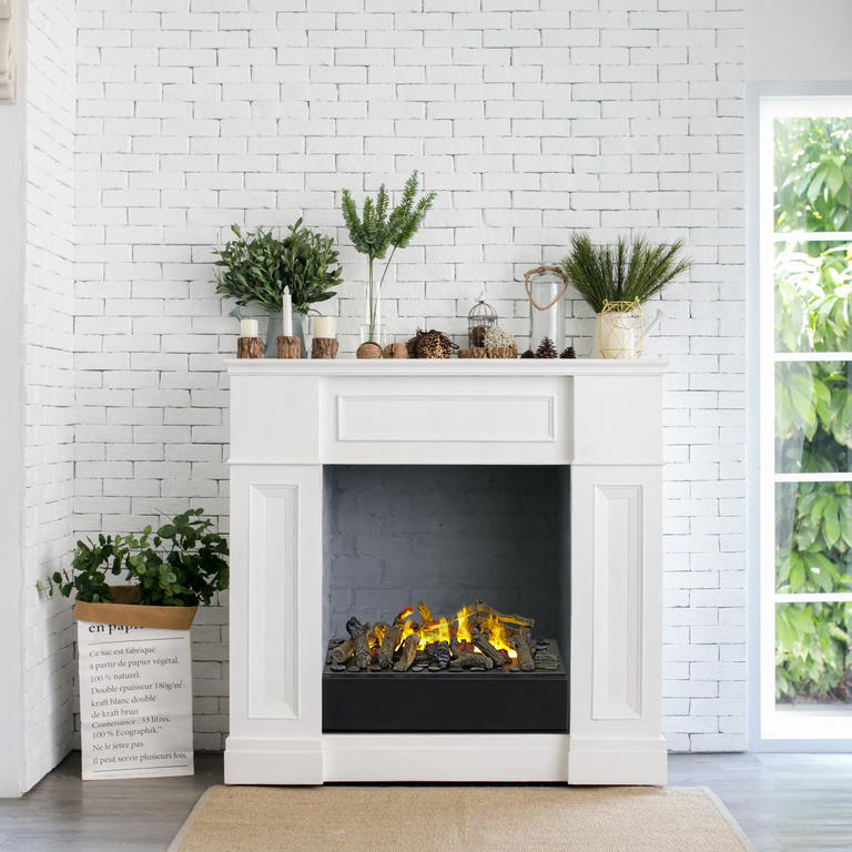 Juneau electric fire in the living room with white creek stone wall built into a white fireplace surround