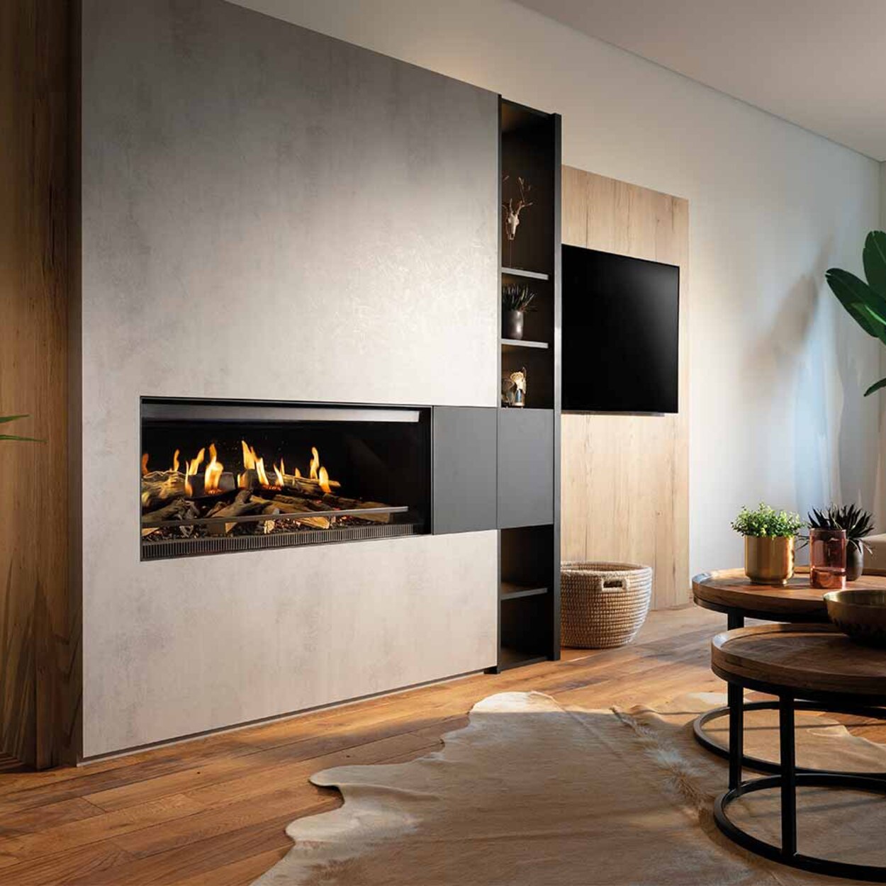 The E-One 100 electric fireplace in the front of a modern living room with plants built into a concrete wall.