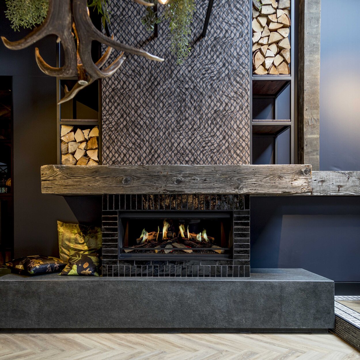 Electric fireplace E-One 100 front rustic installed with wooden elements in a bar.