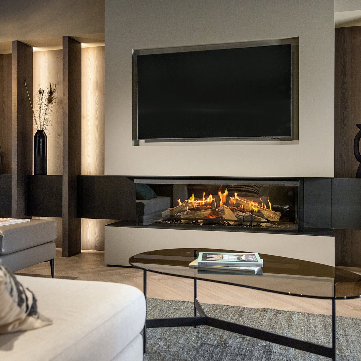 The 3-sided electric fireplace E-One 130 S installed on a wooden wall with special lighting.