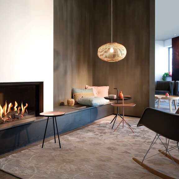Gas fireplace G80/48F on a dark base unit with white panelling in a classic living room with brown wall and carpet