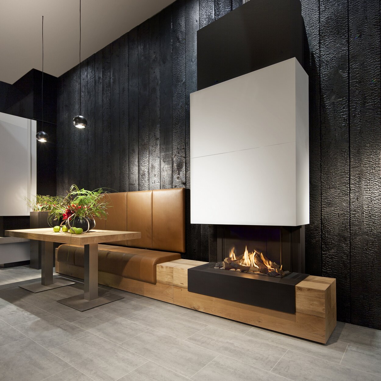 Gas fireplace G70/44S on a wooden base with combined leather bench and white fireplace panelling on a dark wall