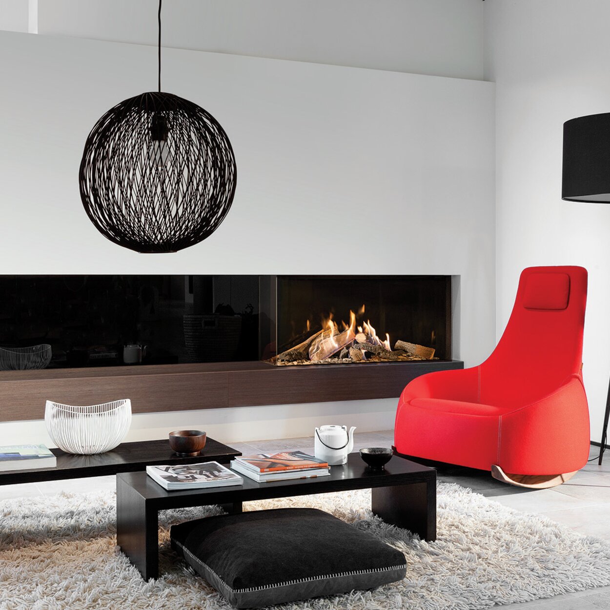 Gas fireplace GP110/55C 2-sided glazed on wooden base with black back wall and white panelling in modern living room