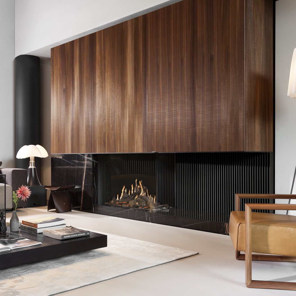 GP110/75C gas fireplace on a stone base with black back panel and wood panelling in a modern living room