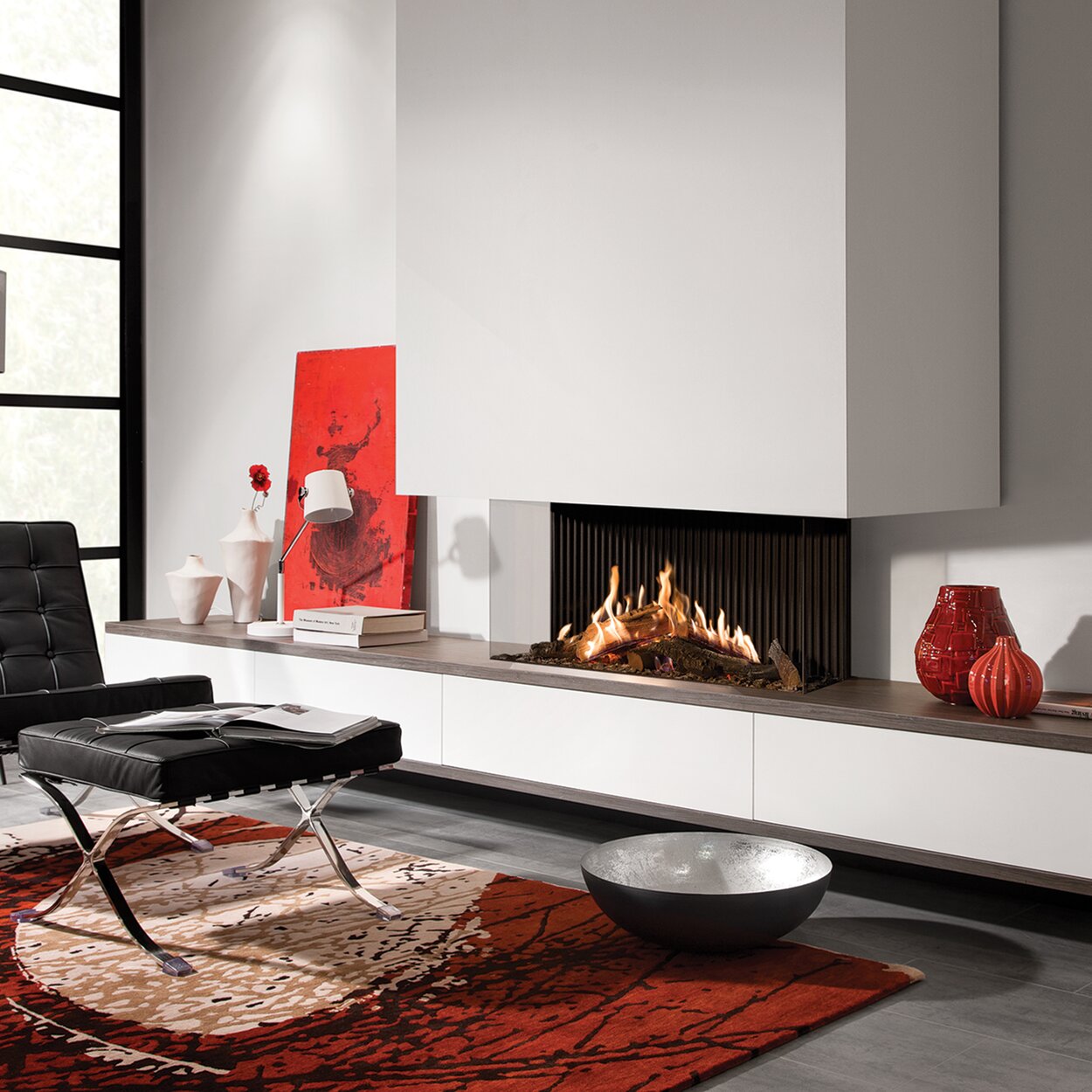 Gas fireplace GP115/55S 3-sided glazed built into white wall in modern living room with leather armchair