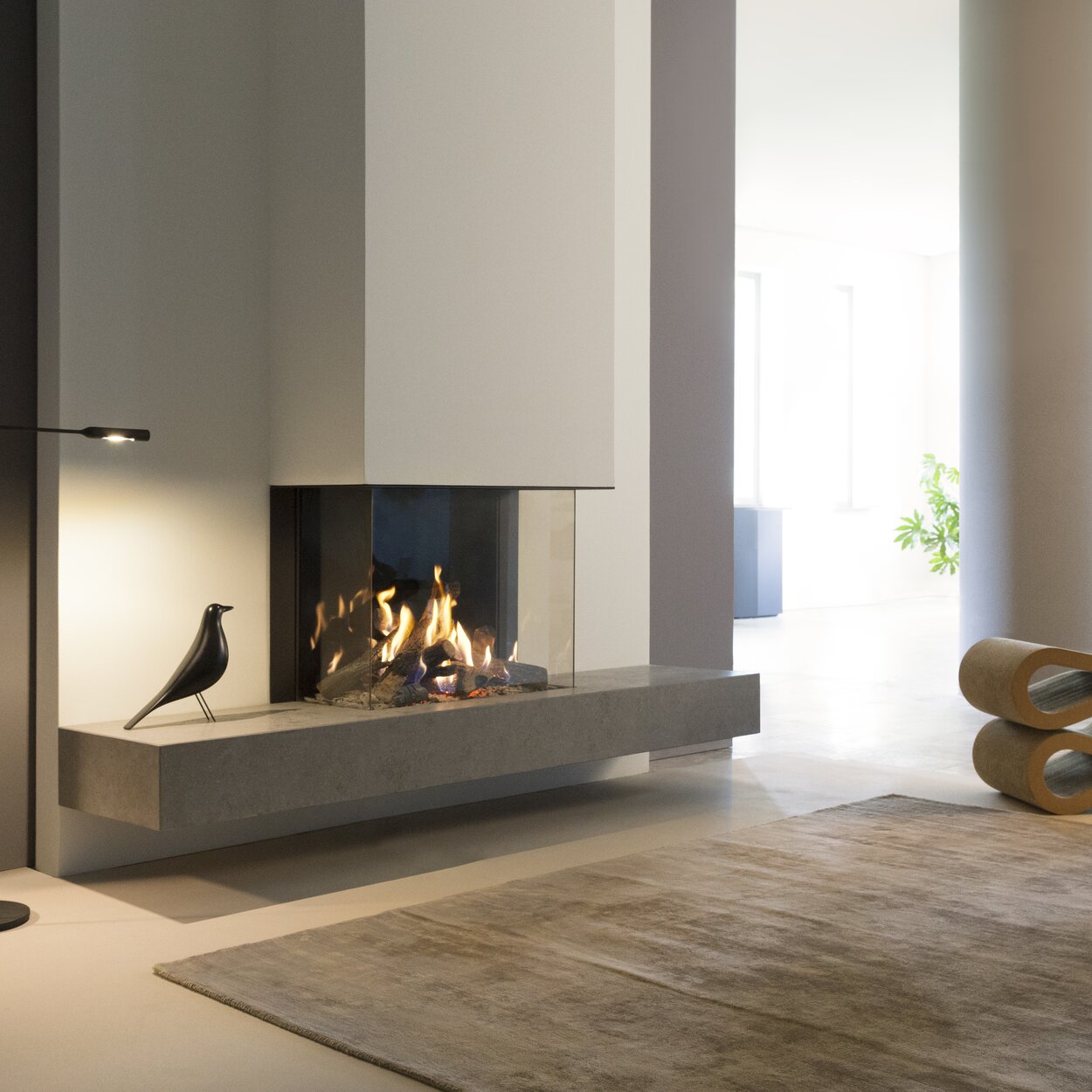 Gas fireplace GP70/55S 3-sided glazed in white wall installed in modern living room with beige tones