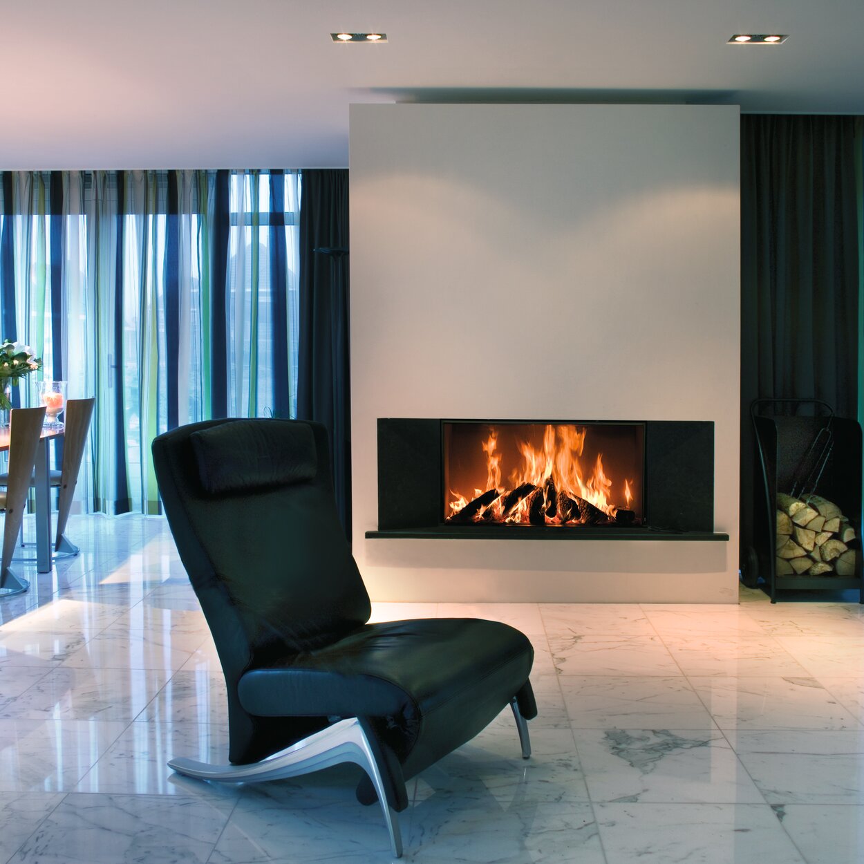 Wood fireplace W105/47F by Kalfire in front version in light-flooded living room with blue curtains