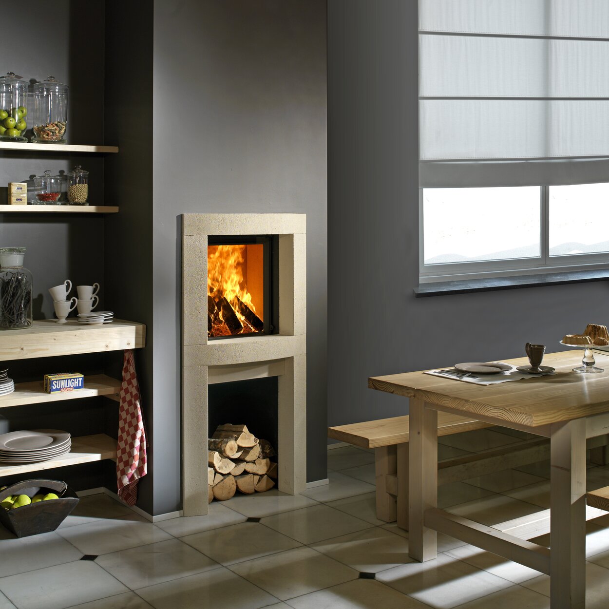Wood fireplace W45/48F by Kalfire in front version as a compact fireplace built into a natural stone niche with practical compartment for wood logs