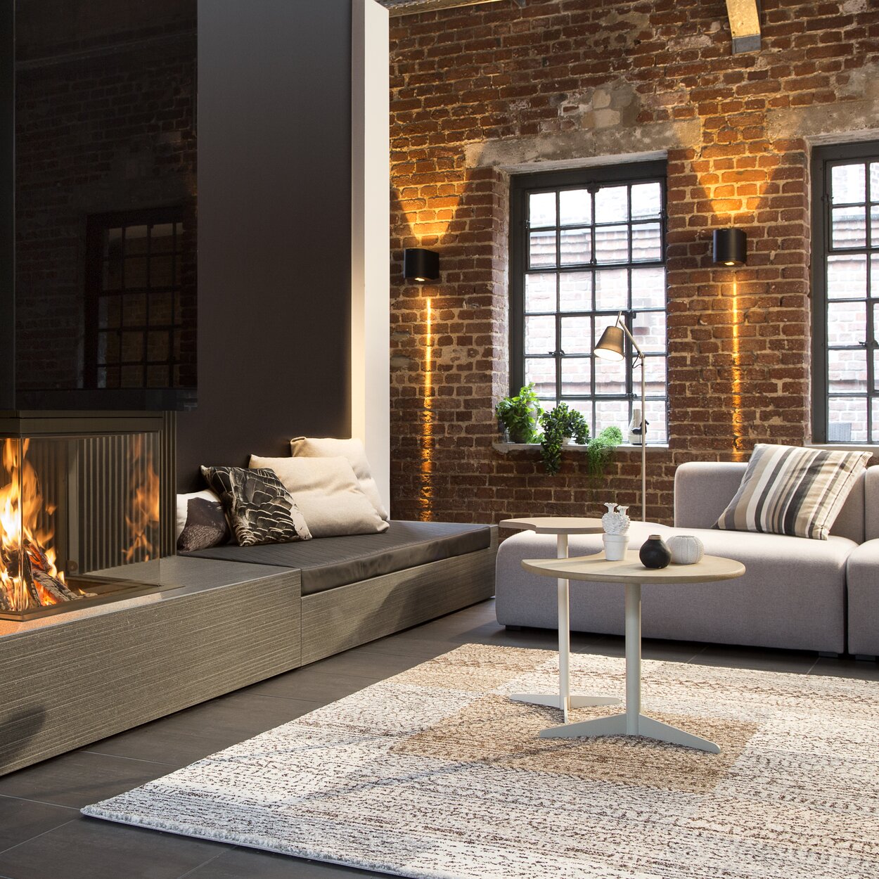 Wood fireplace W66/48S by Kalfire with 3-sided viewing windows in an industrial modernised flat