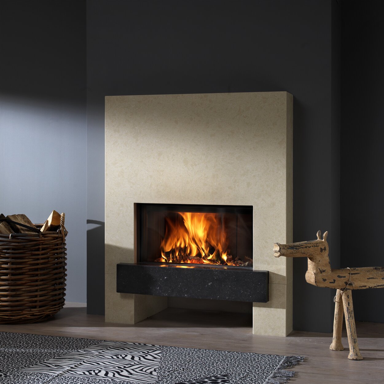 Wood fireplace W70/33F by Kalfire with natural stone cladding in cream-coloured stone against a grey wall