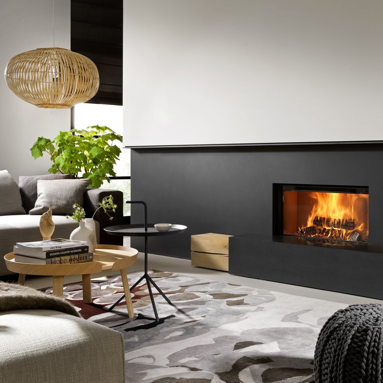 Wood fireplace W85/40F by Kalfire in a black steel front in a small living room